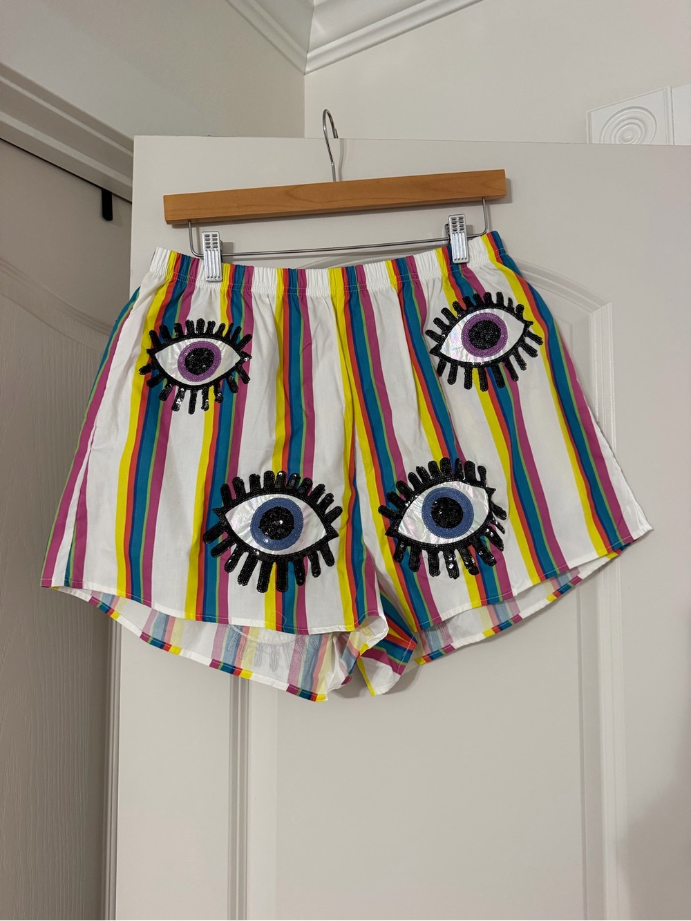 QUEEN OF SPARKLES White Multicolor Striped Athletic Shorts with Eye Appliqués